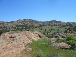 Reddish tan rocks mark the weathered hill tops
