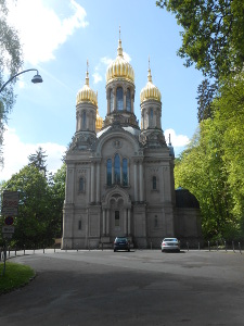 With a tall golden dome in the middle and two golden domes on the sides, the symmetric church is large and impressive