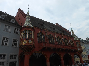 With an arching arcade on the ground floor, and overhanging windows with two oriels, all silvered and gilt, the Freiburg Rathaus, colored terra cotta, is spectacularly beautiful