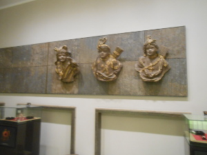 Three elaborately sculpted gilt busts are mounted on the lobby wall of the hotel.