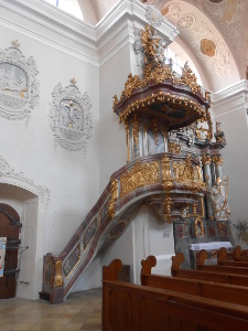 The elaborate pulpit is made from two colors of marble, grey and taupe, richly decorated with carvings and gilt
