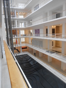 The National Gallery of Czechia is in a large new building in Prague, with a central atrium.  The picture shows six floors surrounding the atrium, at the bottom of which is an art installation