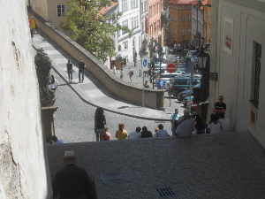 The photo looks down several steep staircases.  Wearing a white straw hat, Bob is in the left foreground.  Groups of people are clustered around the stairs.