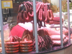 piles and strings of stacked and hanging sausages of many different types tempt the eyes in this storefront