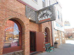 On the left, the Hole in the Wall has a brick facade and advertises Friendly Family Dining and Fine Wines, while on the right the 600 Cafe (named after its street address) has a Pepsi sign and looks more informal.