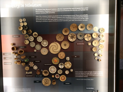 This display has some seventy-five different Native American basketry styles, illustrated by tiny woven baskets.