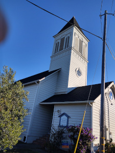 The modern Jewish community in Caspar, CA has repurposed an old Christian church with white clapboards and a bell tower.