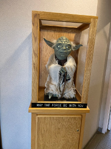 The case displays a model of the Star Wars character Yoda